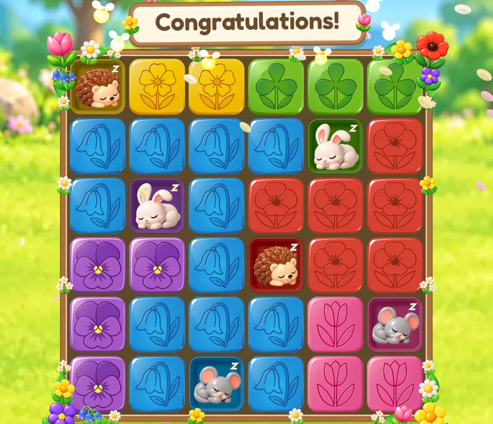 Sleepy Garden: a solved board of glossy flower tiles, sleepy critters on their tiles, Congratulations!